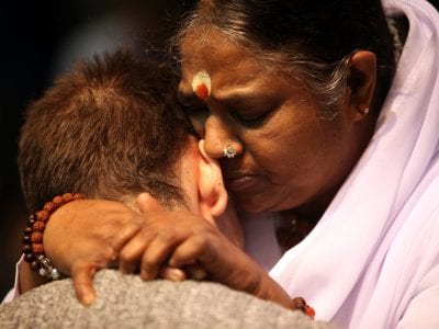 Mata Amritanandamayi "Amma" hugging an ex-convict. Photo courtesy of The Daily Beast.