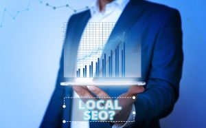 person holding a computer -image labeled with the words local seo?