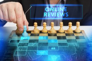 Picture of a hand moving a pawn on a chessboard, and the words "online reviews."