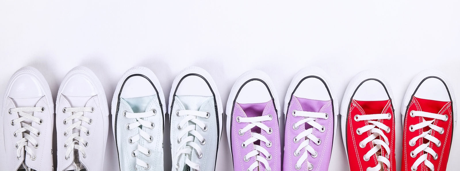Four pairs of converse sneakers in different colors as an example of template based dental websites.